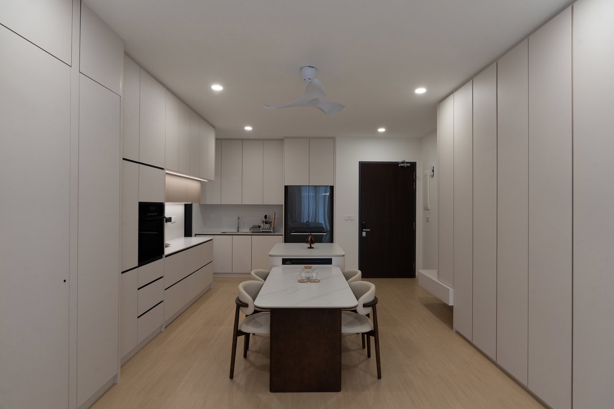 Open kitchen and dining with full-height storage wall