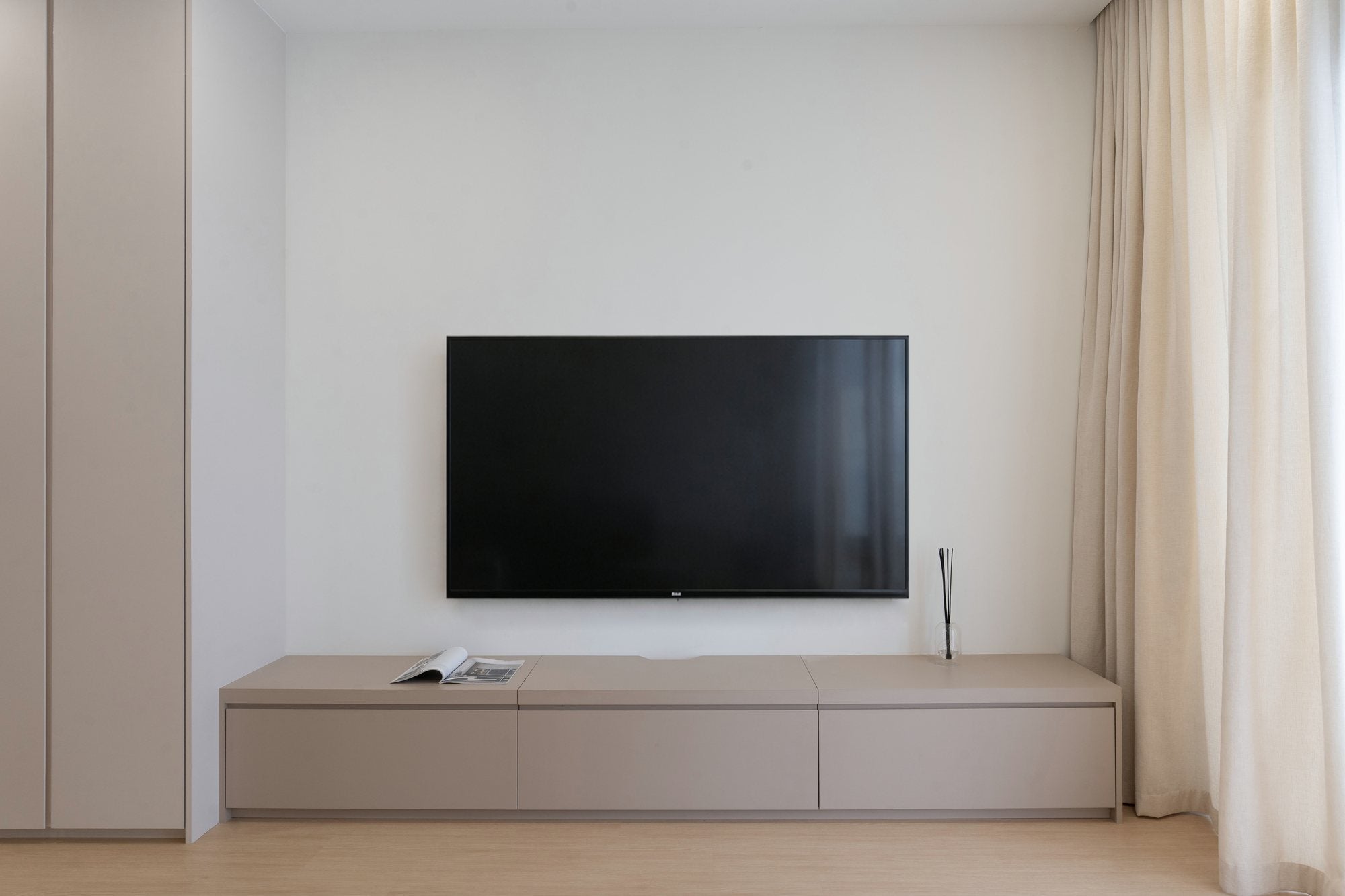 Floating TV console on a cream feature wall