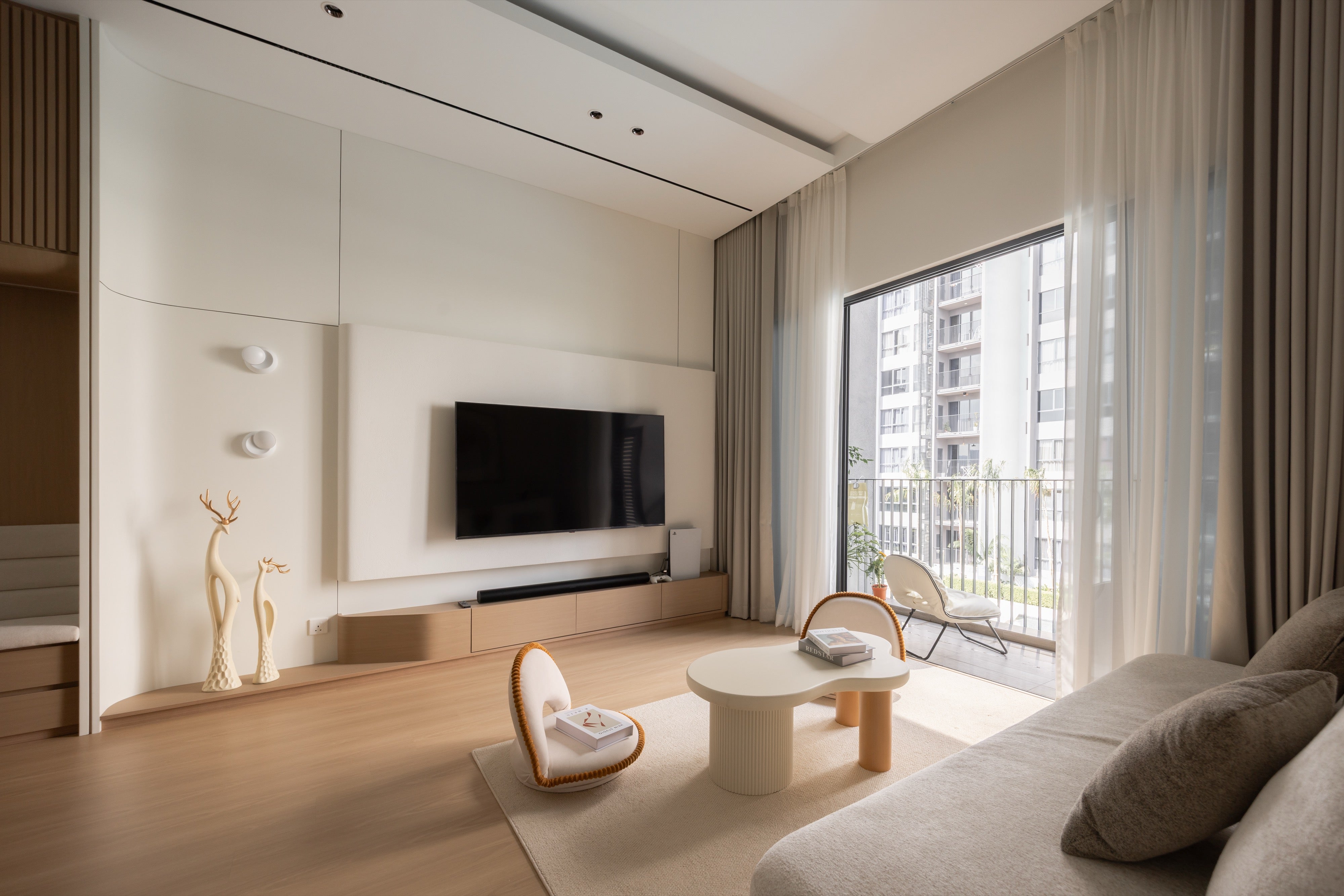 Living hall with curved TV feature wall and balcony light, condo interior design Subang Jaya