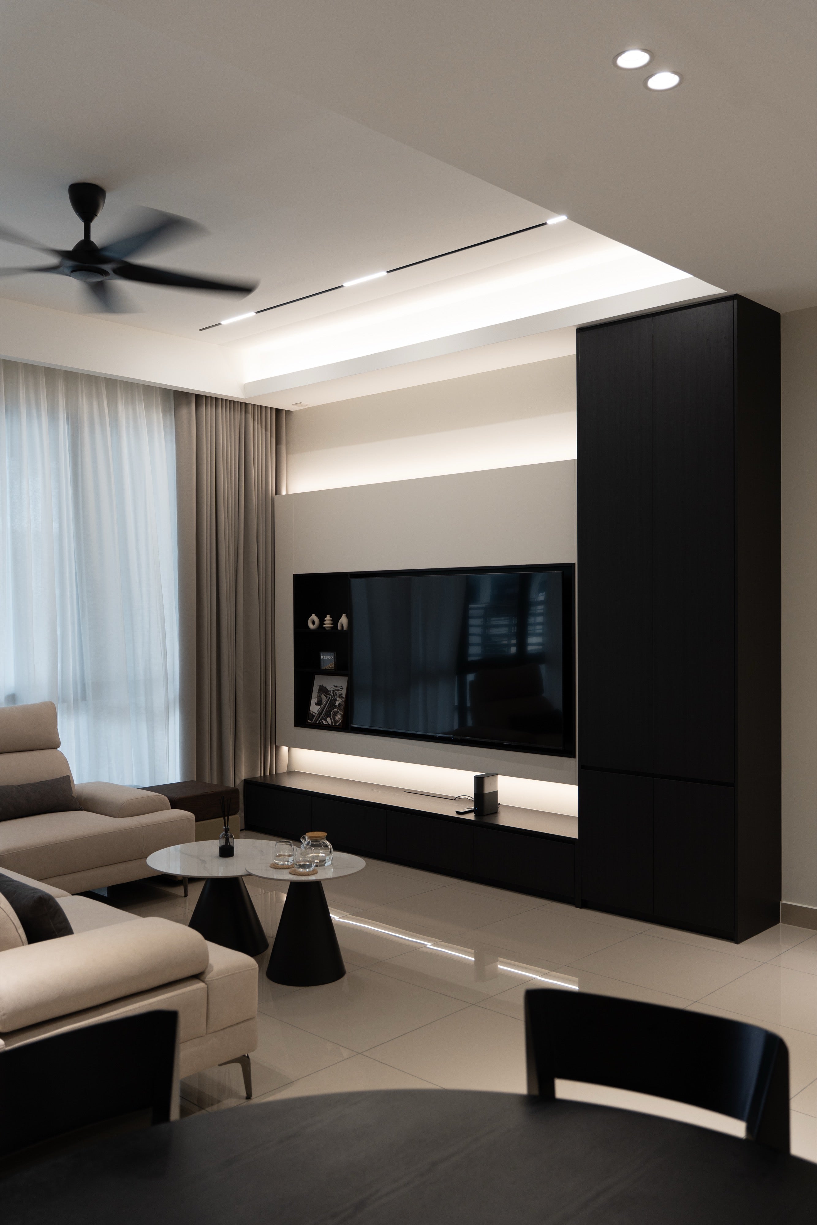 Living room cove ceiling, TV console and black tall cabinet in a Bukit Puchong landed home