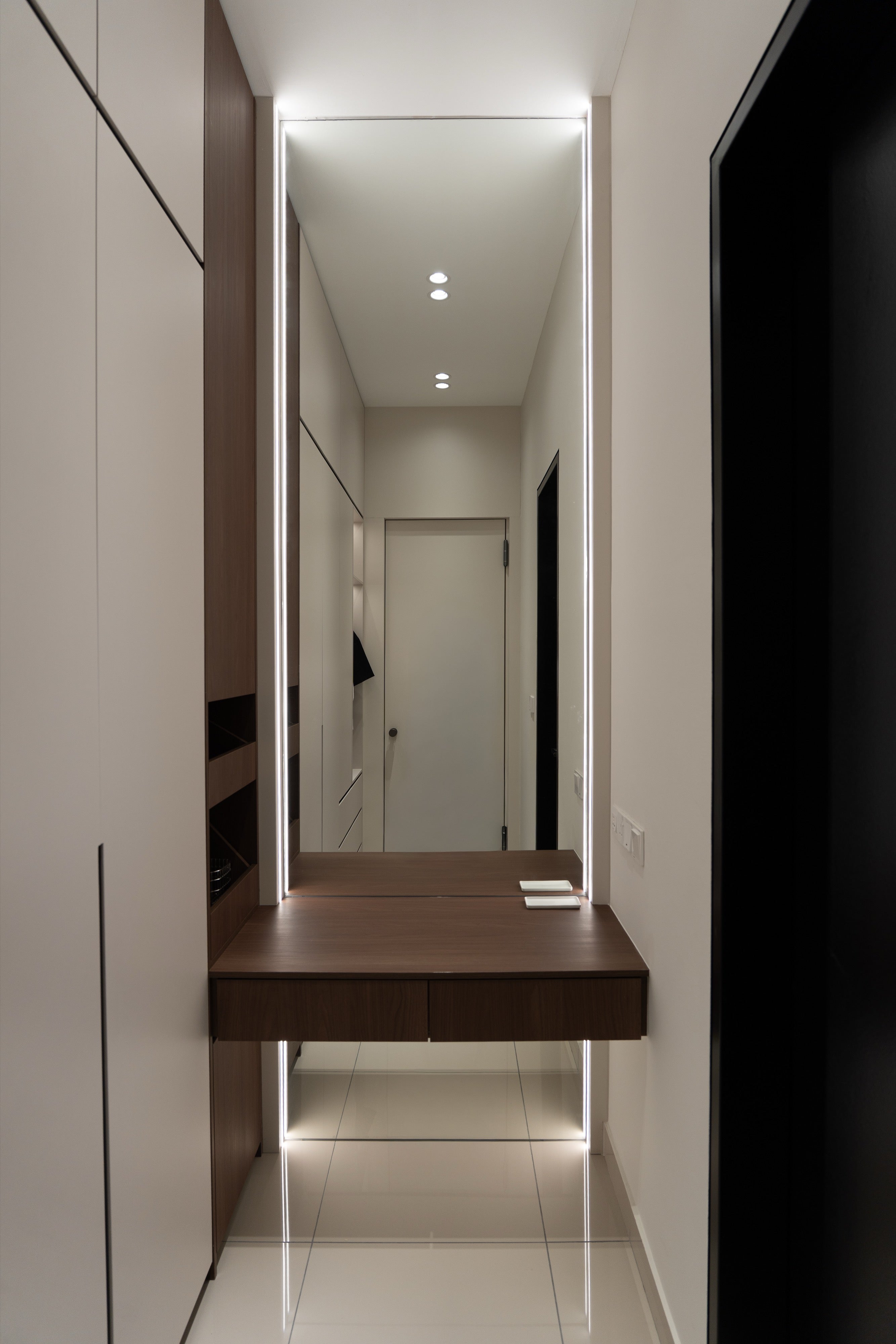 Floating dressing table with LED framed mirror in the walk-in wardrobe