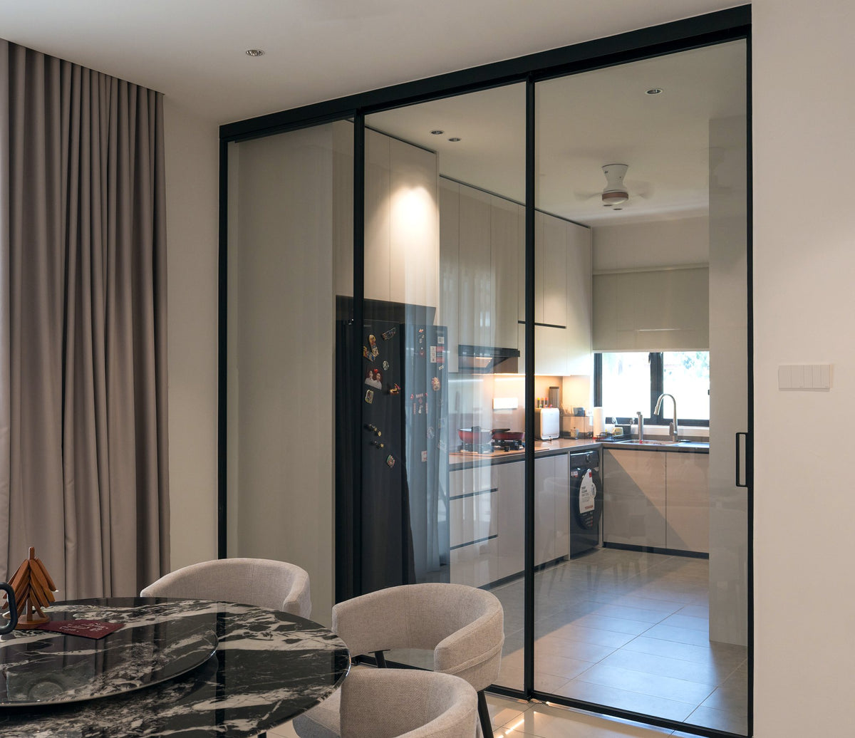 Wet kitchen behind black-framed glass sliding doors