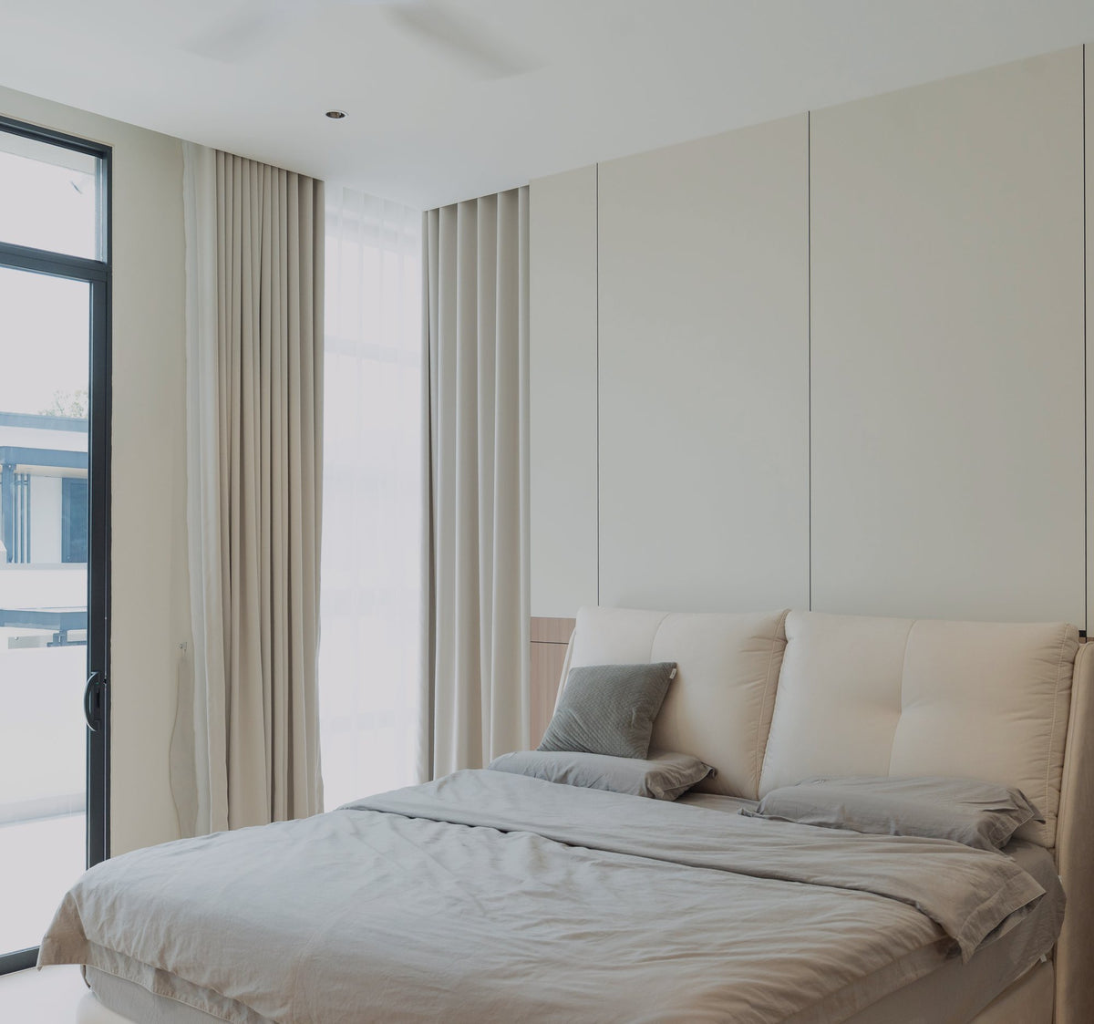 Bedroom with padded bedhead panel and white panelling