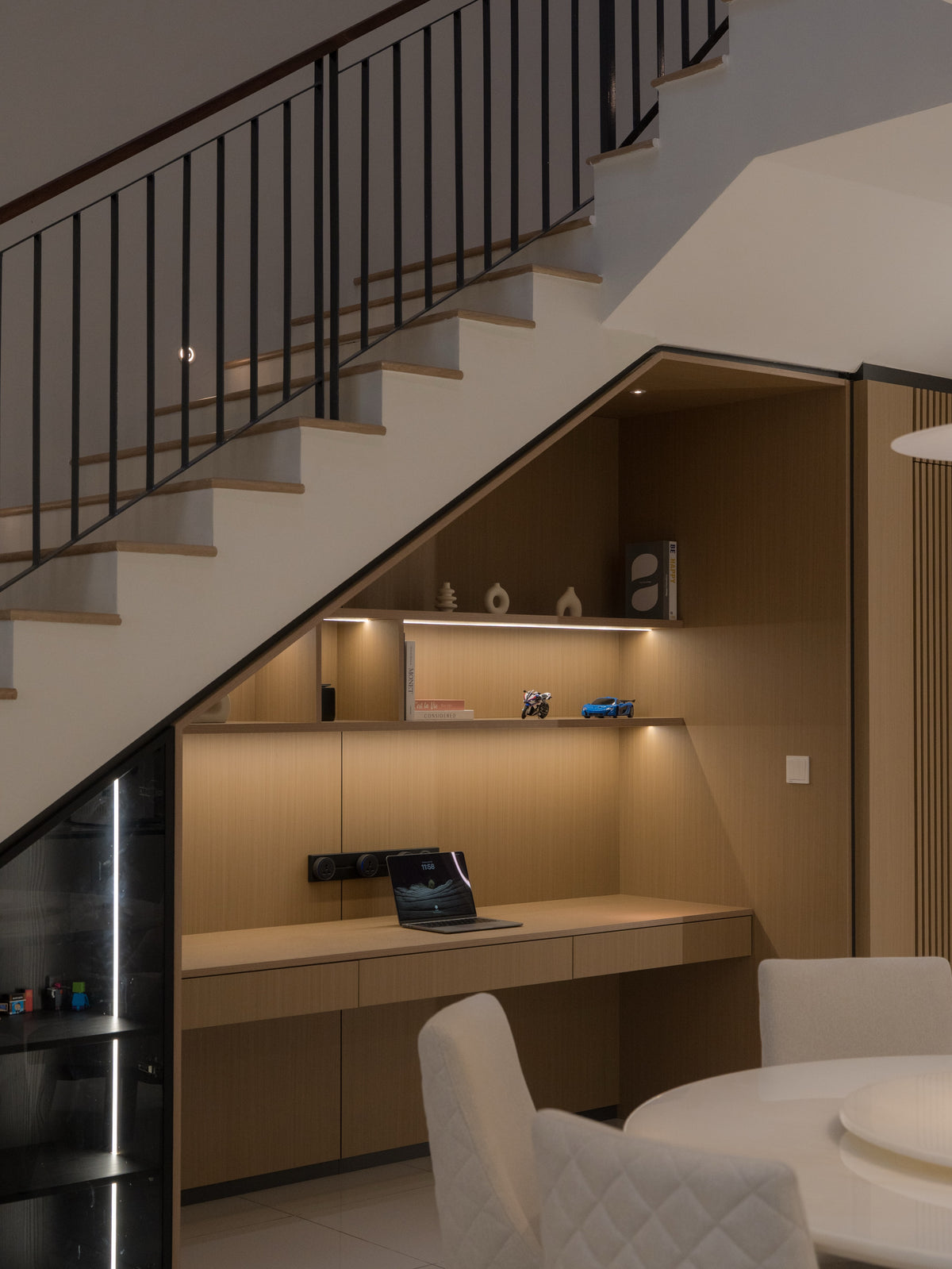 Custom under stair study nook with built in desk and shelves
