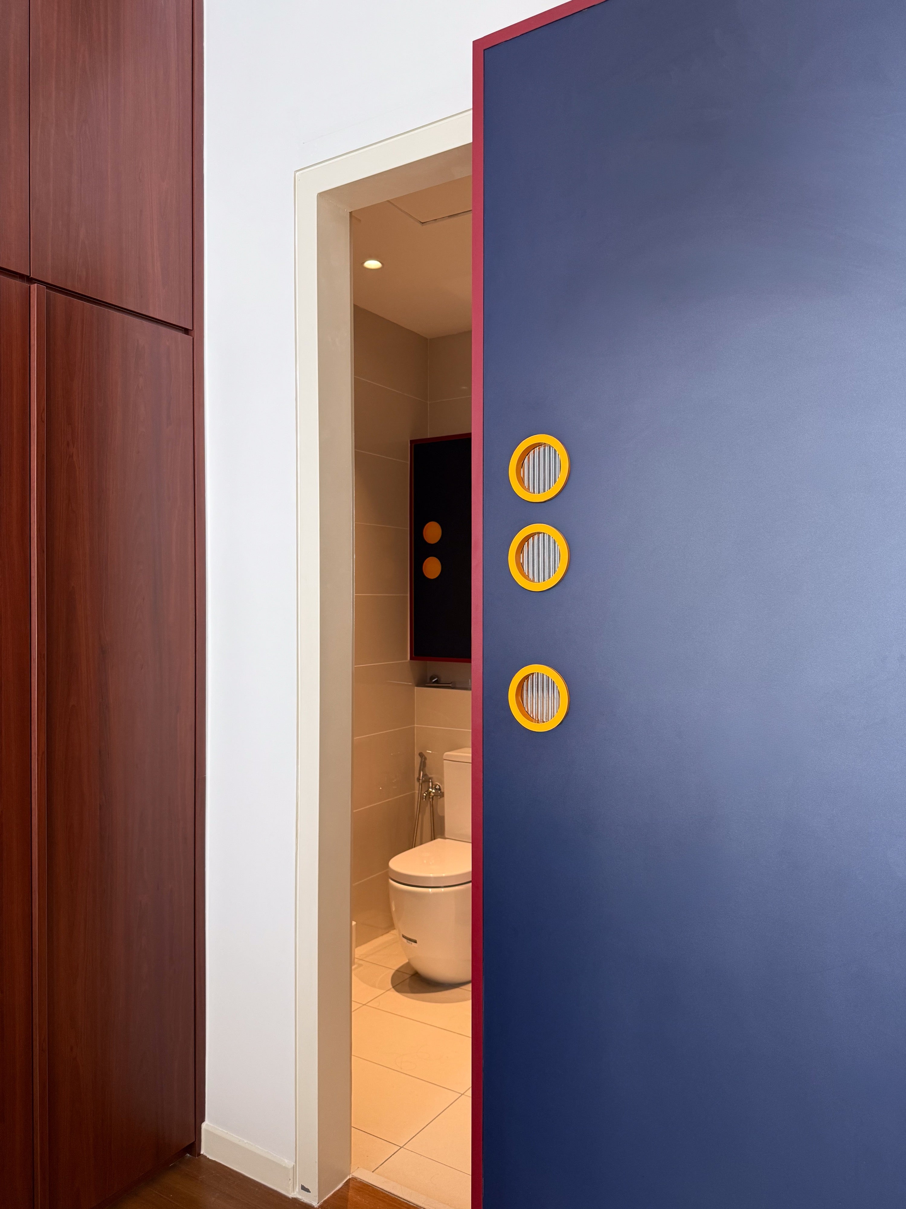 Navy sliding bathroom door with three round porthole windows and red edge, The Maple OUG